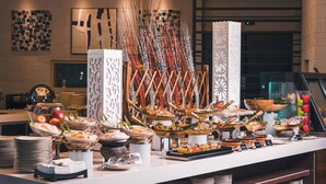 A buffet setup with various dishes and decorative elements. - Ancasa Royale Pekan Pahang (Pekan)