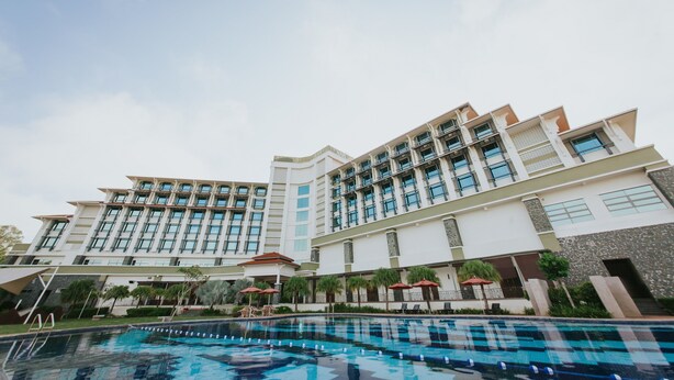 A modern hotel with a swimming pool, multiple balconies, and outdoor seating areas. - Ancasa Royale Pekan Pahang (Pekan)
