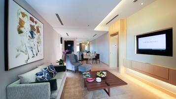 A modern living room with a sofa, coffee table, and artwork on the wall.