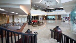 A spacious lobby with a piano, seating area, and a staircase. - Ancasa Royale Pekan Pahang (Pekan)