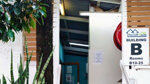 A staircase leading to Building B, rooms B10-25, with a sign indicating the building name and room numbers. - The Cliff House (Kangaroo Point)