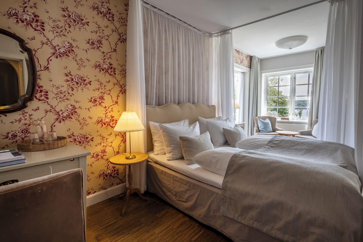 Phòng Suite phong cách lãng mạn, ban công, quang cảnh biển | Bộ đồ giường cao cấp, bàn, khu vực làm việc phù hợp cho laptop 