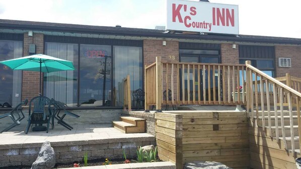 A K's Country Inn with outdoor seating and a wooden deck.