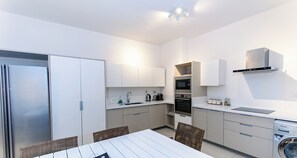 A compact kitchen with a refrigerator, microwave, oven, and a dishwasher. - Cap Ouest by Dream Escapes (Flic-en-Flac)