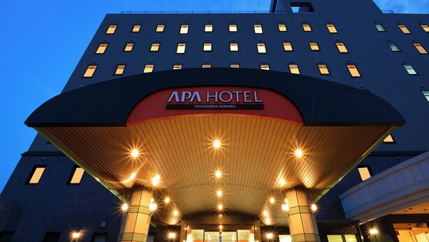 The APA HOTEL entrance with a modern design, featuring a prominent red and black sign, multiple illuminated windows, and a well-lit facade. - APA Hotel Kagoshima Kokubu (Kirishima)
