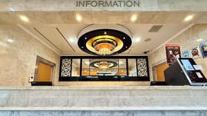 A lobby with a marble floor, a chandelier, and a reception desk. - APA Hotel Kagoshima Kokubu (Kirishima)