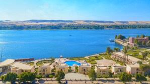 Un resort con piscina, villas frente a la playa y vistas al lago.