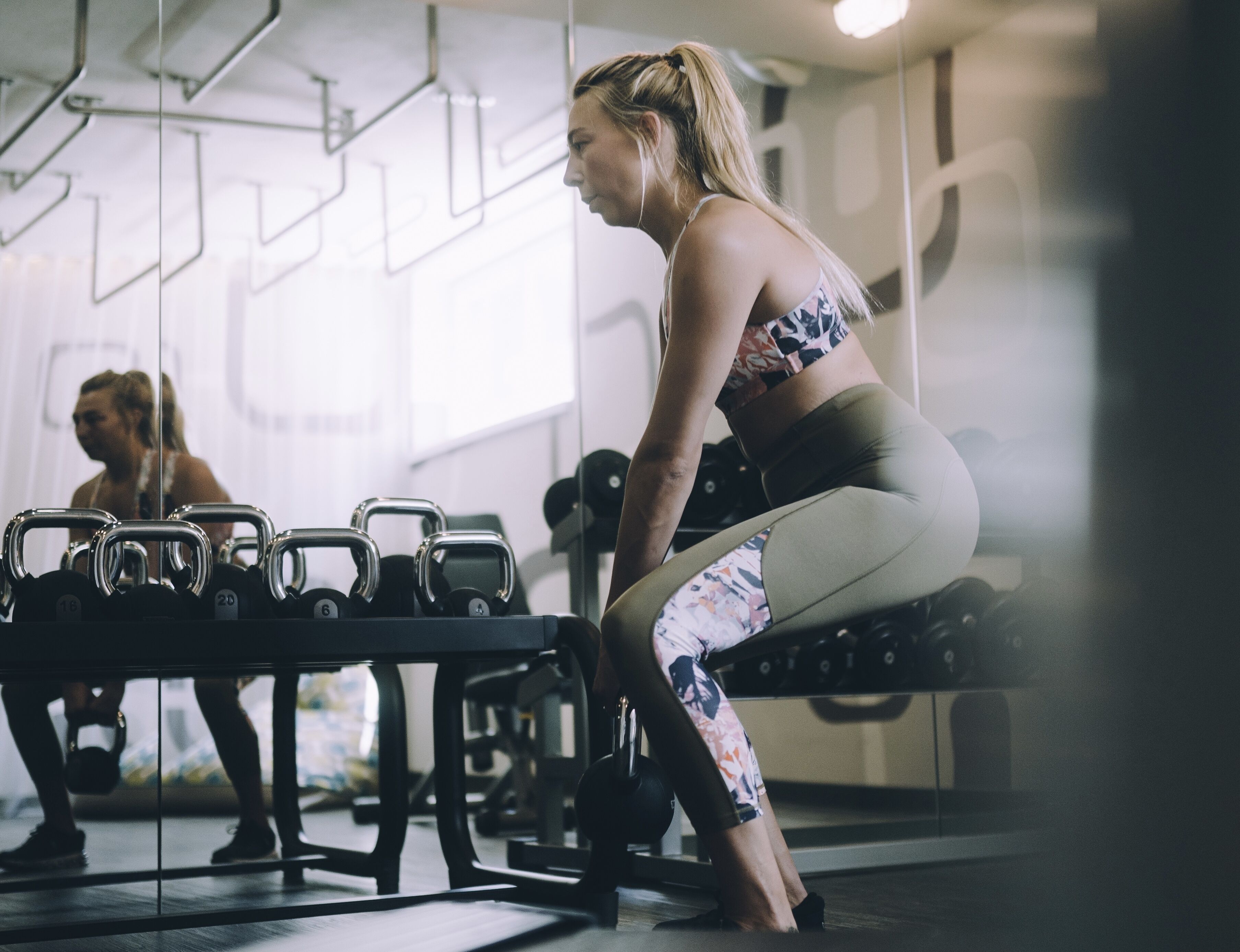 A gym with exercise equipment, including dumbbells and a bench.