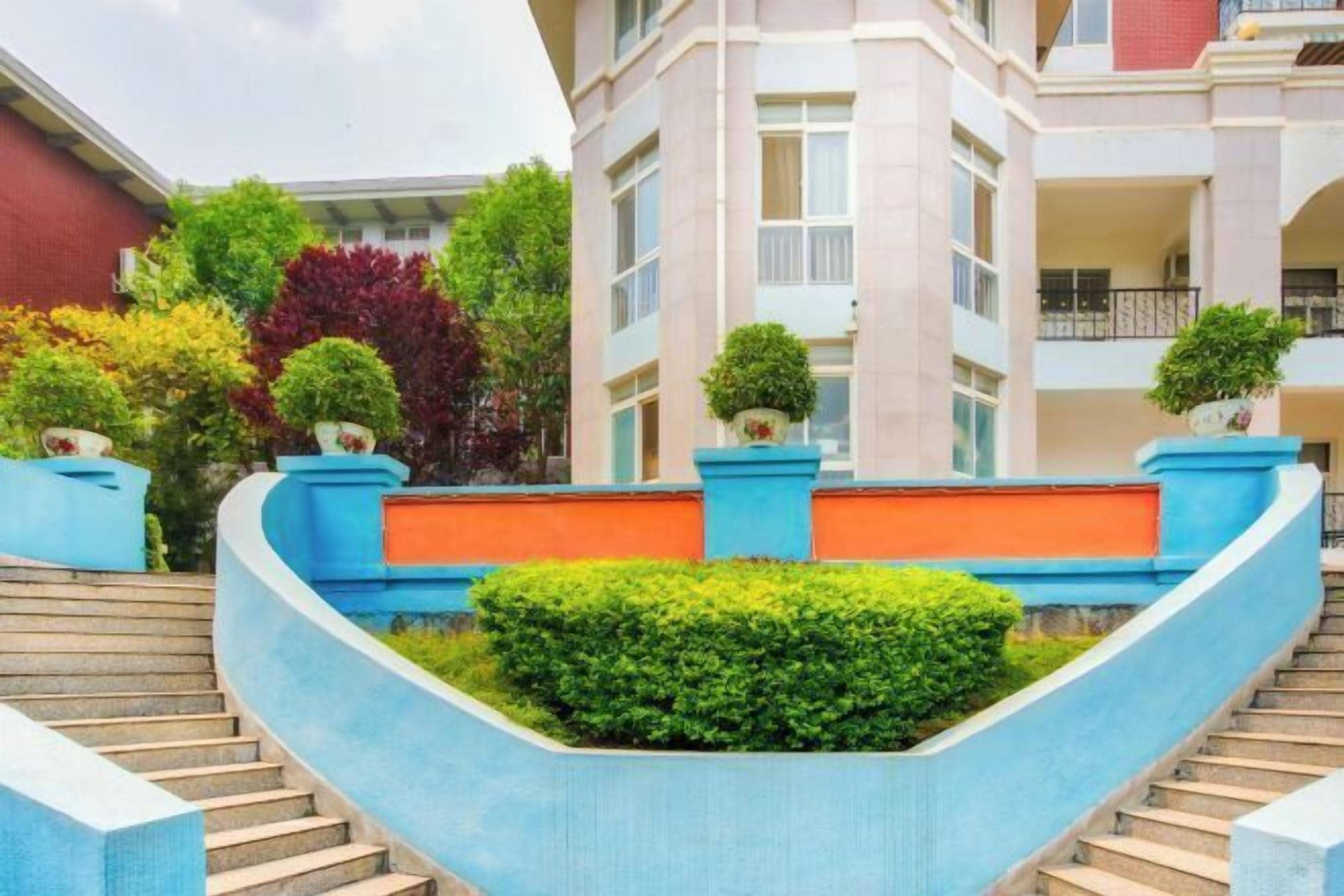 A multi-story building with a curved staircase leading to a landing.