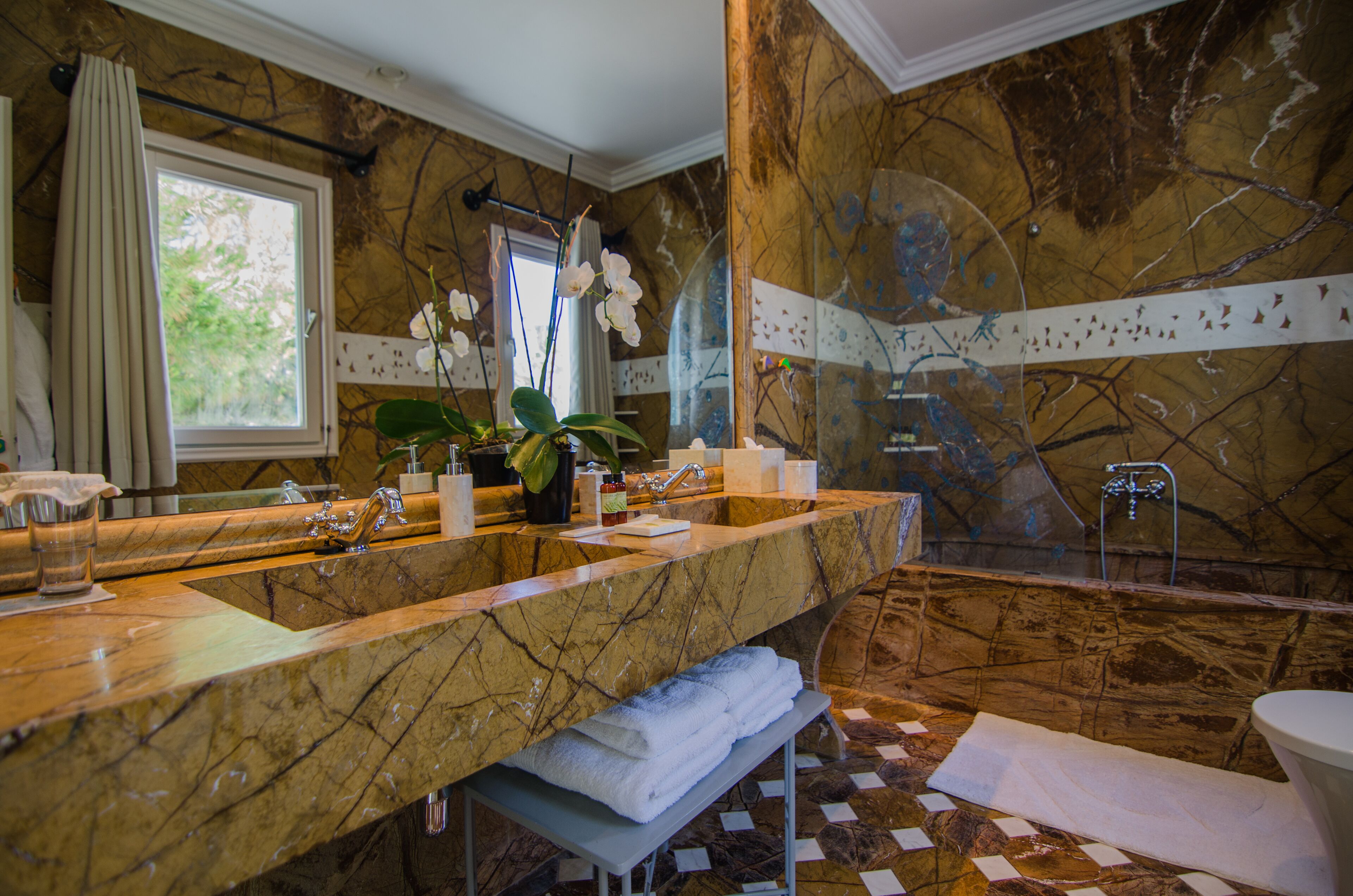 deluxe suite | bathroom | designer toiletries, hair dryer, bathrobes, slippers
