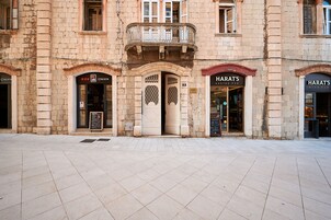 A building with two storefronts, one labeled "IZAKAYA" and the other "HARAT'S Irish Pub".