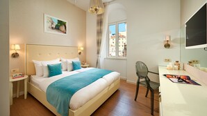 A neatly arranged hotel room with a bed, bedside tables, a desk, and a chair. - Marmont City Rooms (Split)