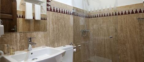 A bathroom with a sink, toilet, and shower.