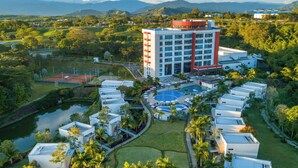 A resort with multiple white buildings, a central pool, and surrounding greenery. - Hotel Sonesta Pereira (Pereira)
