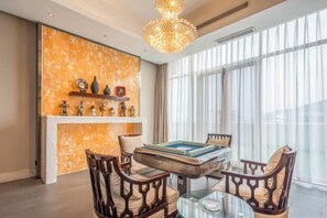 A room with a pool table, wooden chairs, a chandelier, and a fireplace. - Prestton Hotel (Jinan)