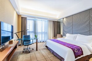 A hotel room with a bed, a desk with a TV, a chair, and a window with curtains. - Metropolo Shaoxing Keqiao Wanda Square (Shaoxing)