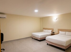 A hotel room with two beds, a desk, a chair, and an air conditioning unit. - CHN Hotel Monterrey Santa Fe (Monterrey)