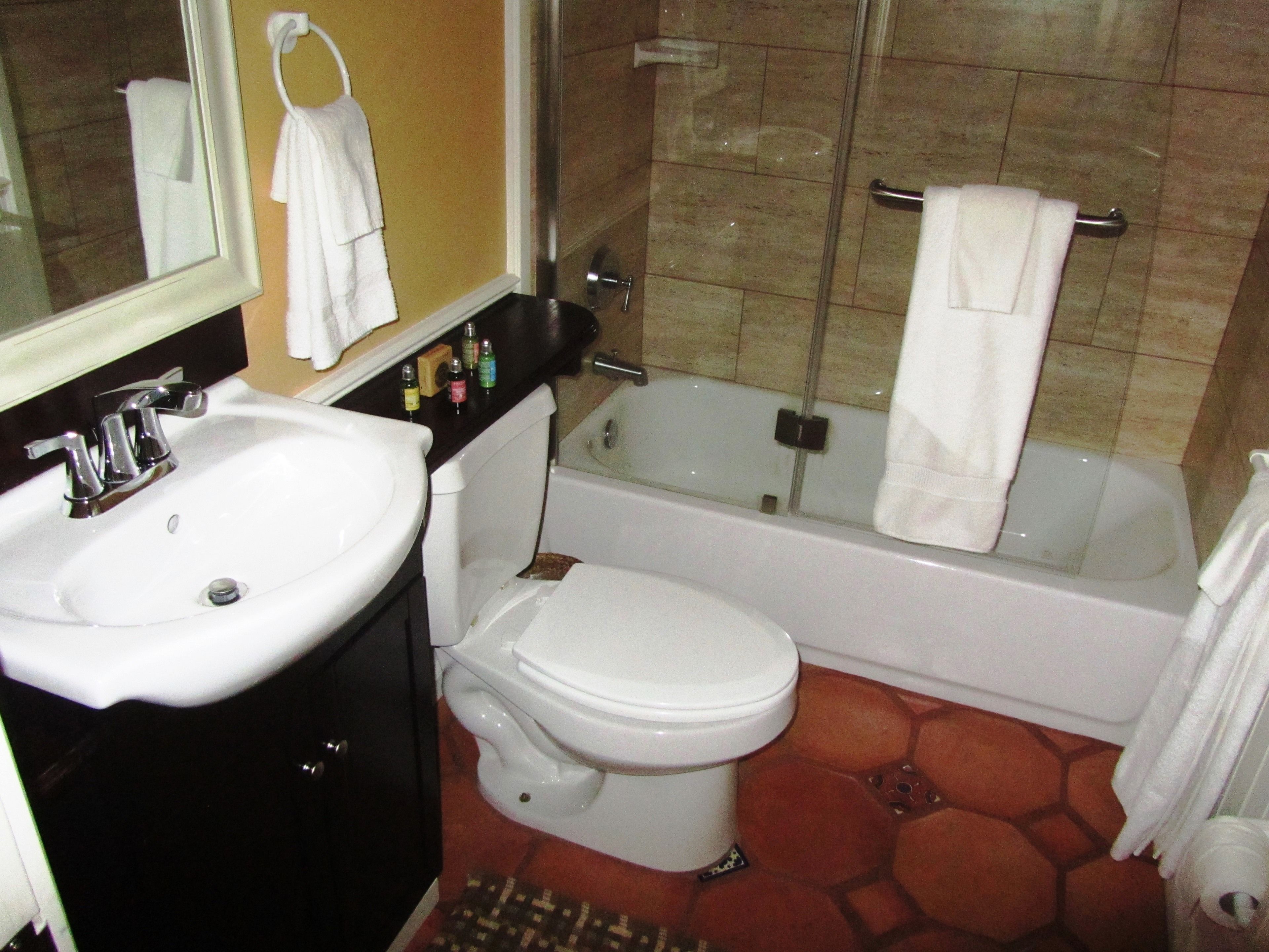 A bathroom with a sink, toilet, and bathtub.