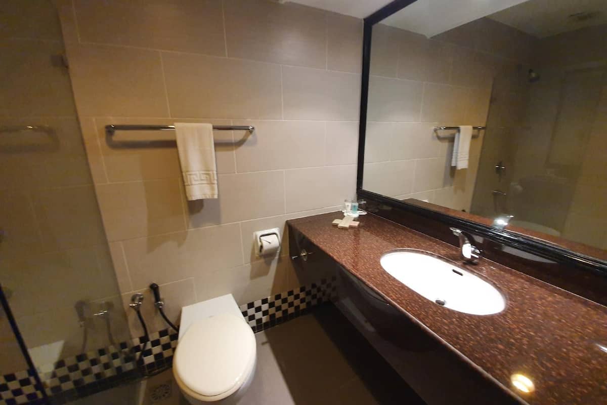 superior room, 1 king bed | bathroom | free toiletries, hair dryer, slippers, towels