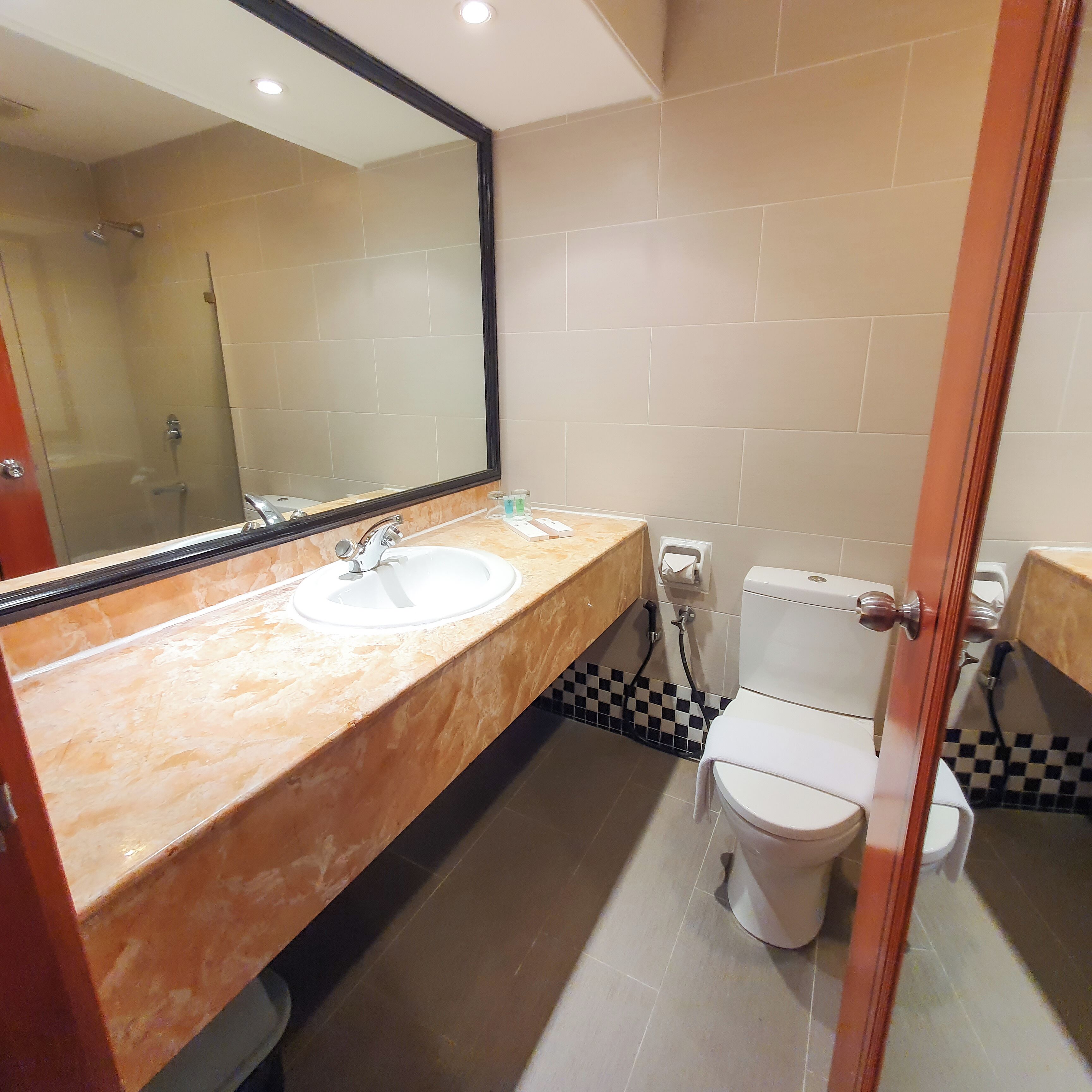 deluxe room, 1 king bed | bathroom | free toiletries, hair dryer, slippers, towels