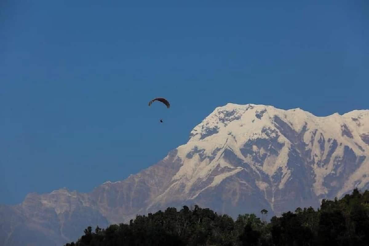 A mountain with a snow-capped peak and a clear sky.