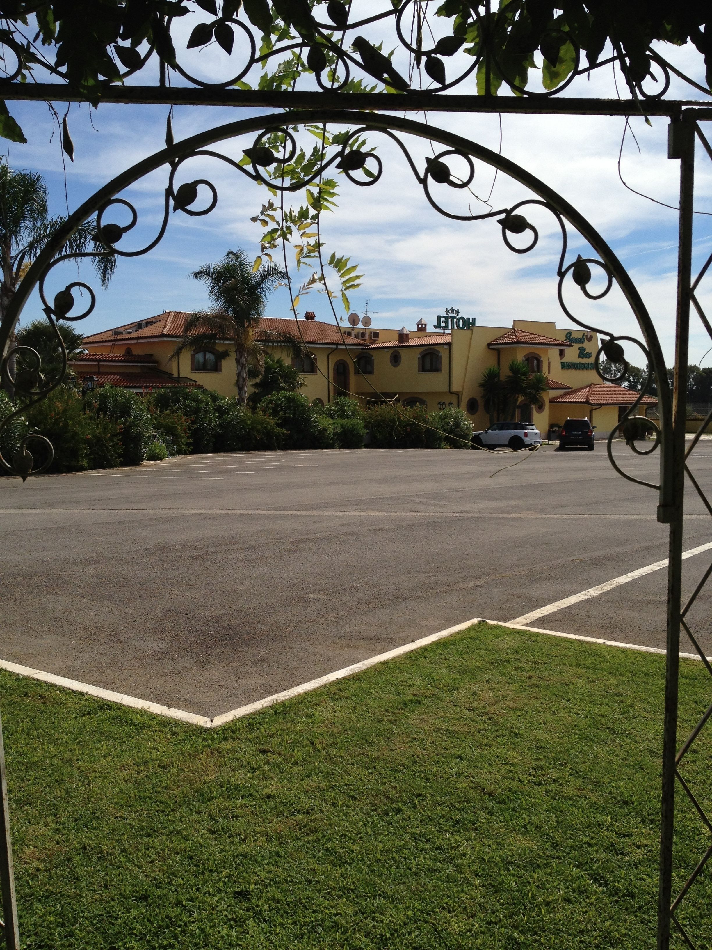A parking lot with a building in the background.