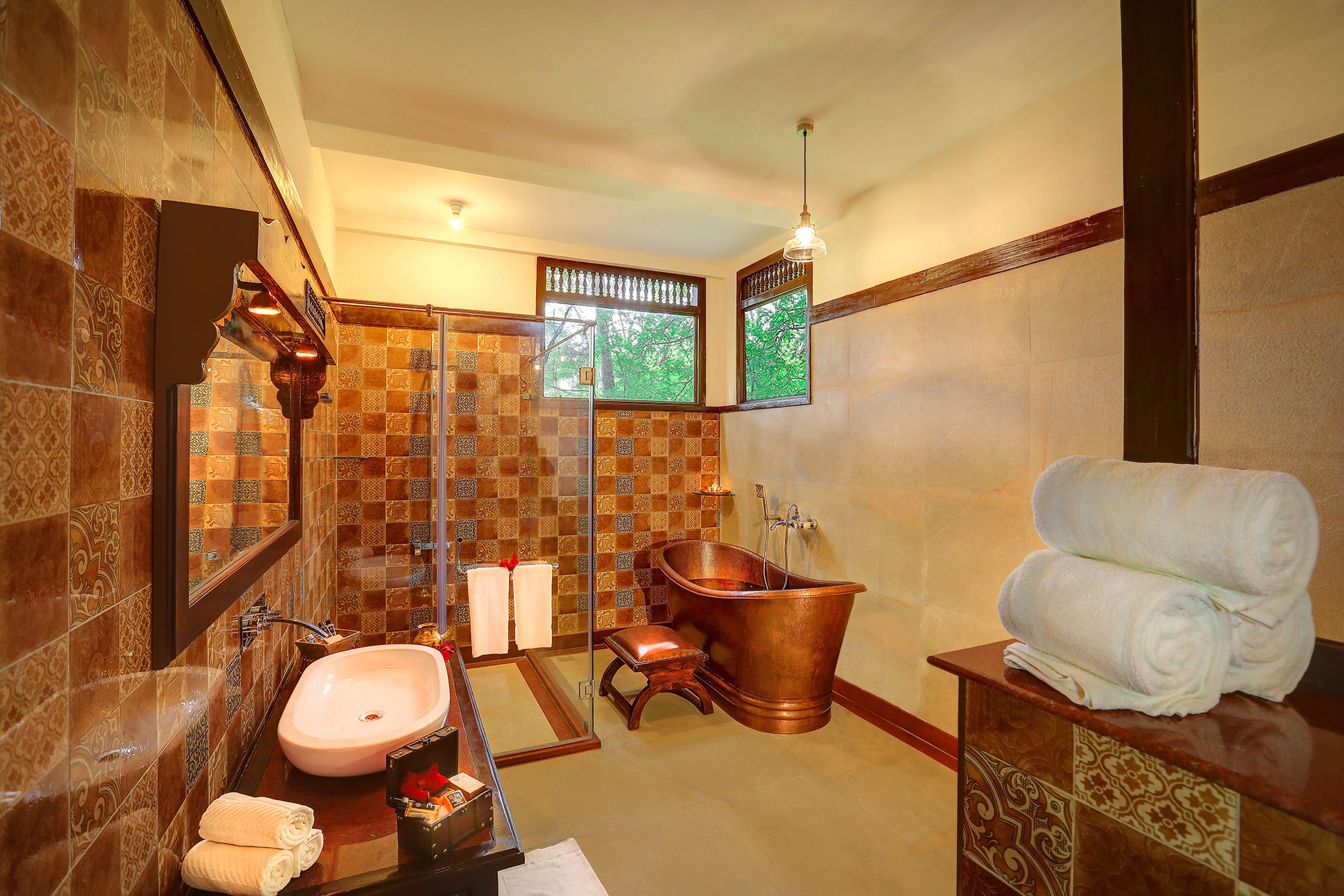 A bathroom with a freestanding bathtub, a sink, and a mirror.