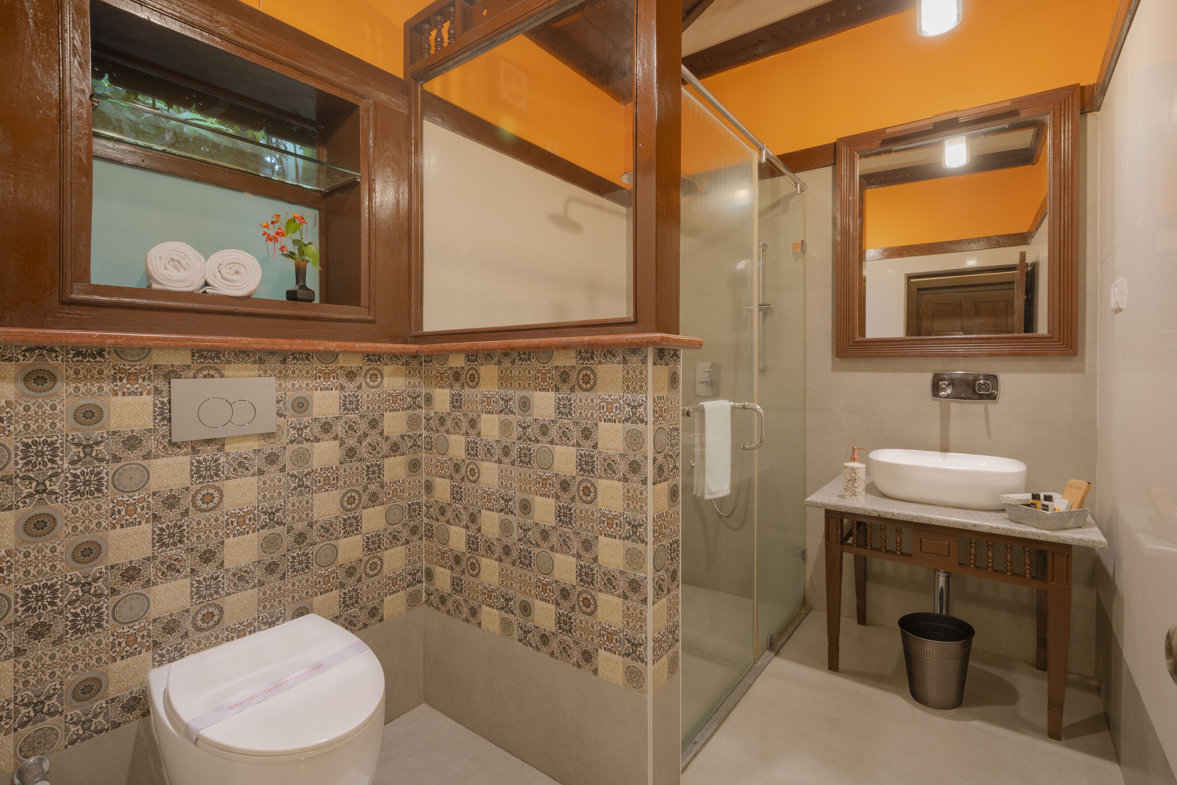 A bathroom with a toilet, sink, and shower.