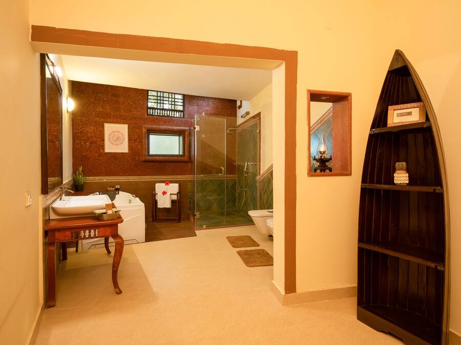 A bathroom with a sink, toilet, and shower area.