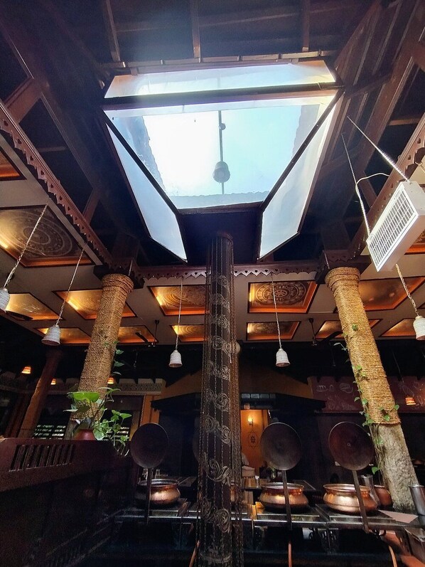 A room with a skylight, wooden beams, and traditional decor.