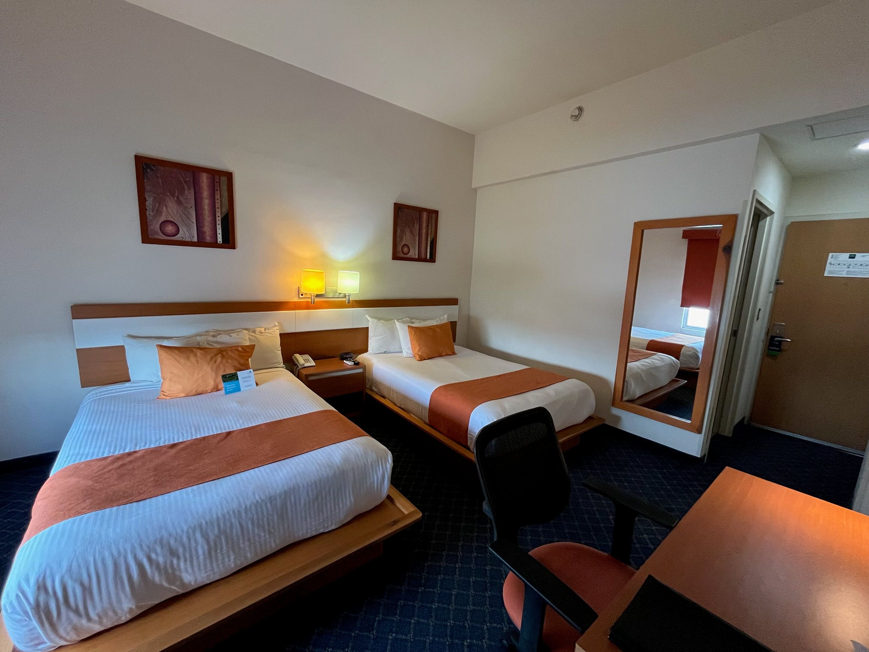standard double room, 2 double beds | in-room safe, desk, laptop workspace, iron/ironing board