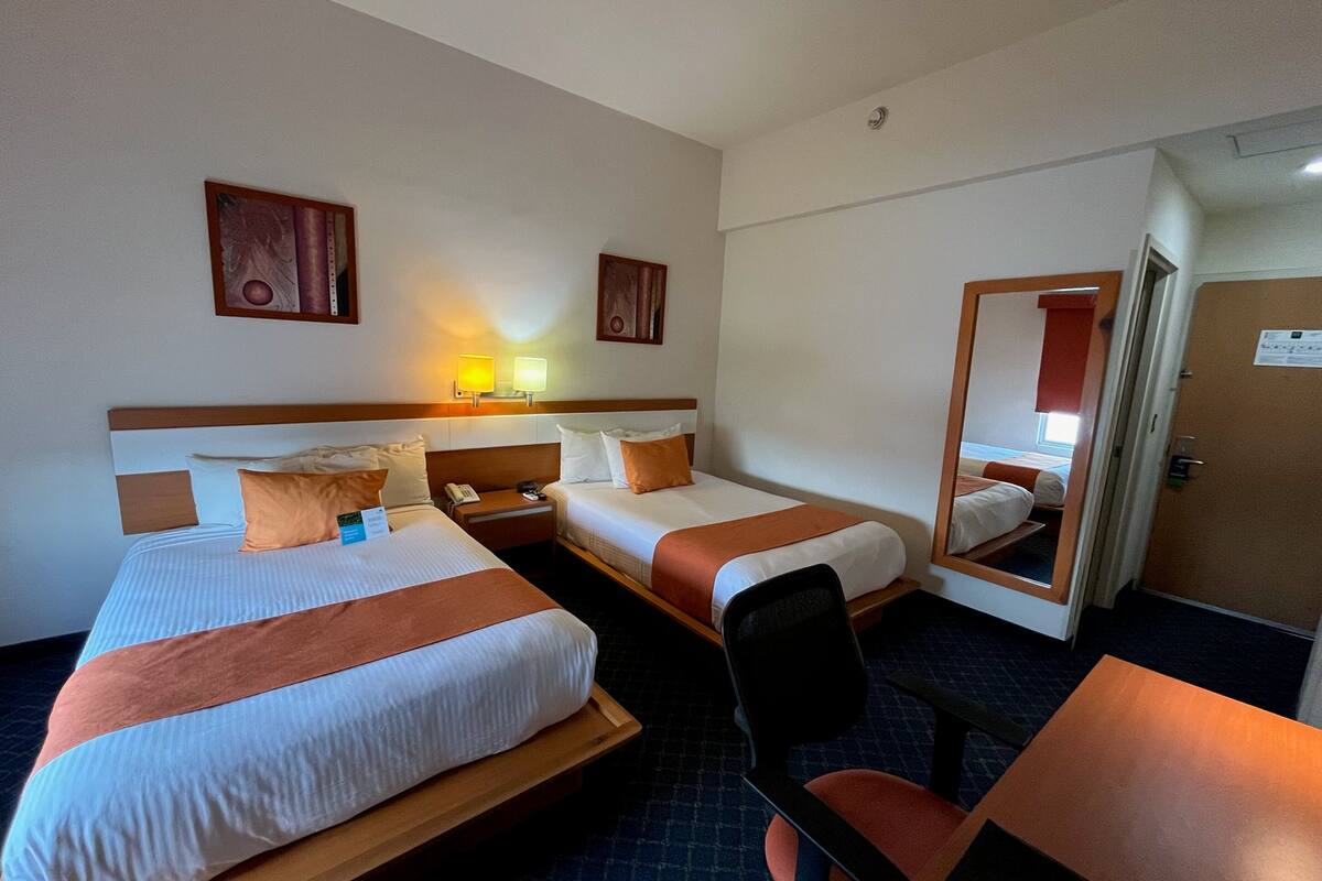standard double room, 2 double beds | in-room safe, desk, laptop workspace, iron/ironing board