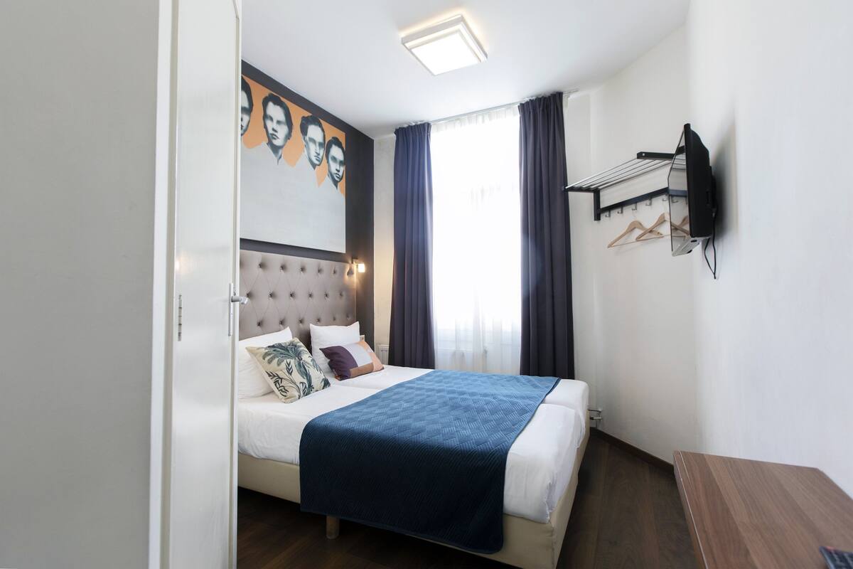 Twin Room | Desk, blackout drapes, iron/ironing board (on request), cribs (free)