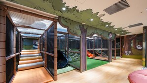 A children's play area with a slide, soft play surfaces, and a netted climbing structure. - HOTEL COZZI Ximen Tainan (Tainan)