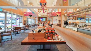 A brightly lit restaurant with a central buffet table, wooden furniture, and a large hanging decoration. - HOTEL COZZI Ximen Tainan (Tainan)