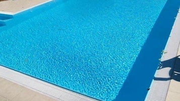 Seasonal outdoor pool, pool umbrellas, pool loungers