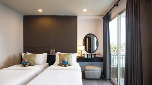 A hotel room with two beds, a small table with a lamp, a round mirror, and a view of the outdoors through a sliding door. - Somerset Vientiane (Vientiane)