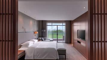 A modern hotel room with a large bed, a flat-screen TV, and a balcony with a view of the city.