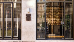 A hotel facade with large glass windows, a sign reading 'Palazzo Navona Hotel,' and a star rating of three stars.