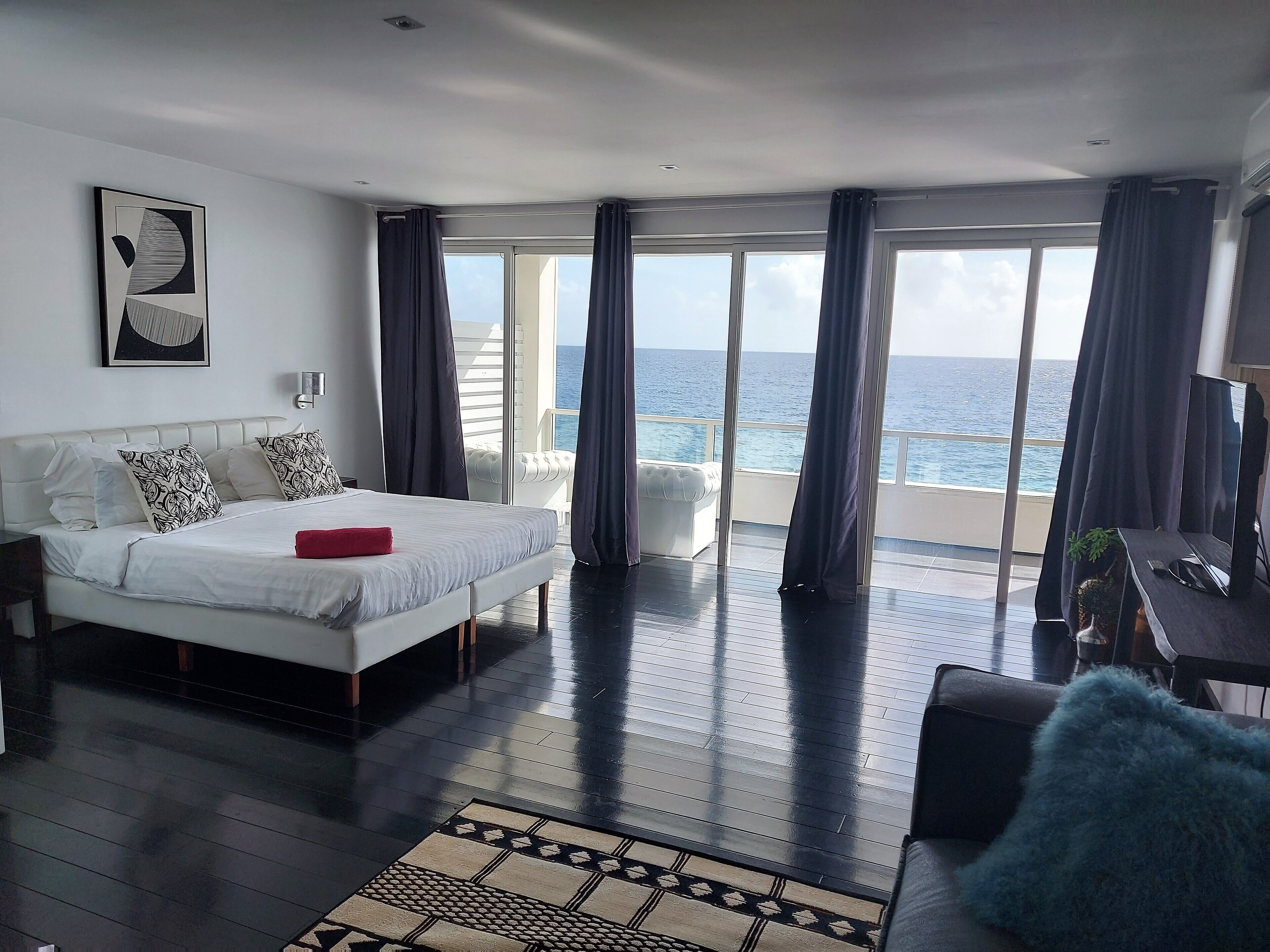 junior suite, multiple beds, oceanfront | living area | smart tv