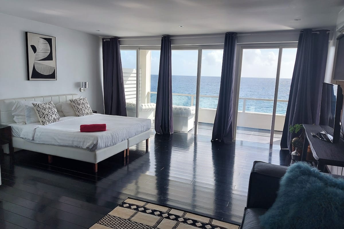 junior suite, multiple beds, oceanfront | living area | smart tv