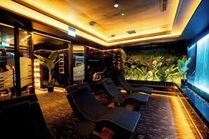 A modern lounge area with seating and a large wall-mounted screen. - Tara Hotel (Killybegs)