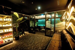 A modern interior with a reception desk, seating area, and a display of products. - Tara Hotel (Killybegs)