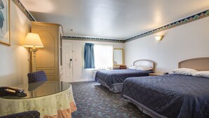 A hotel room with two beds, a desk with a lamp, a telephone, and a window with curtains. - Best Whittier Inn (Whittier)