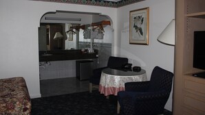 A compact hotel room with a dining area, a small kitchenette, and a TV. - Best Whittier Inn (Whittier)
