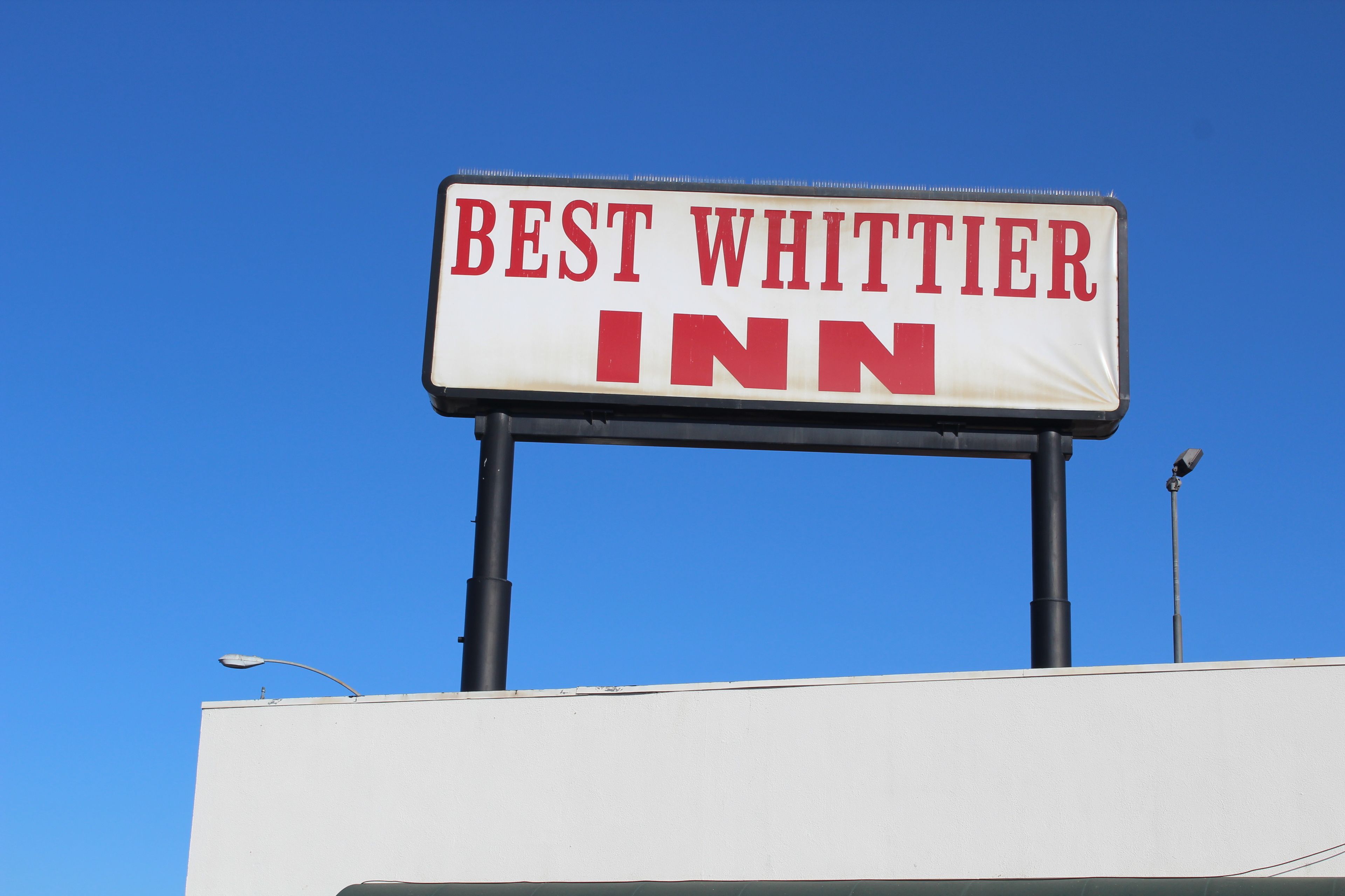 A sign for the Best Whittier Inn.