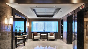 A modern lobby with a marble floor, a reception desk, seating area, and a large window with curtains. - Mercure Istanbul Bomonti (Istanbul)