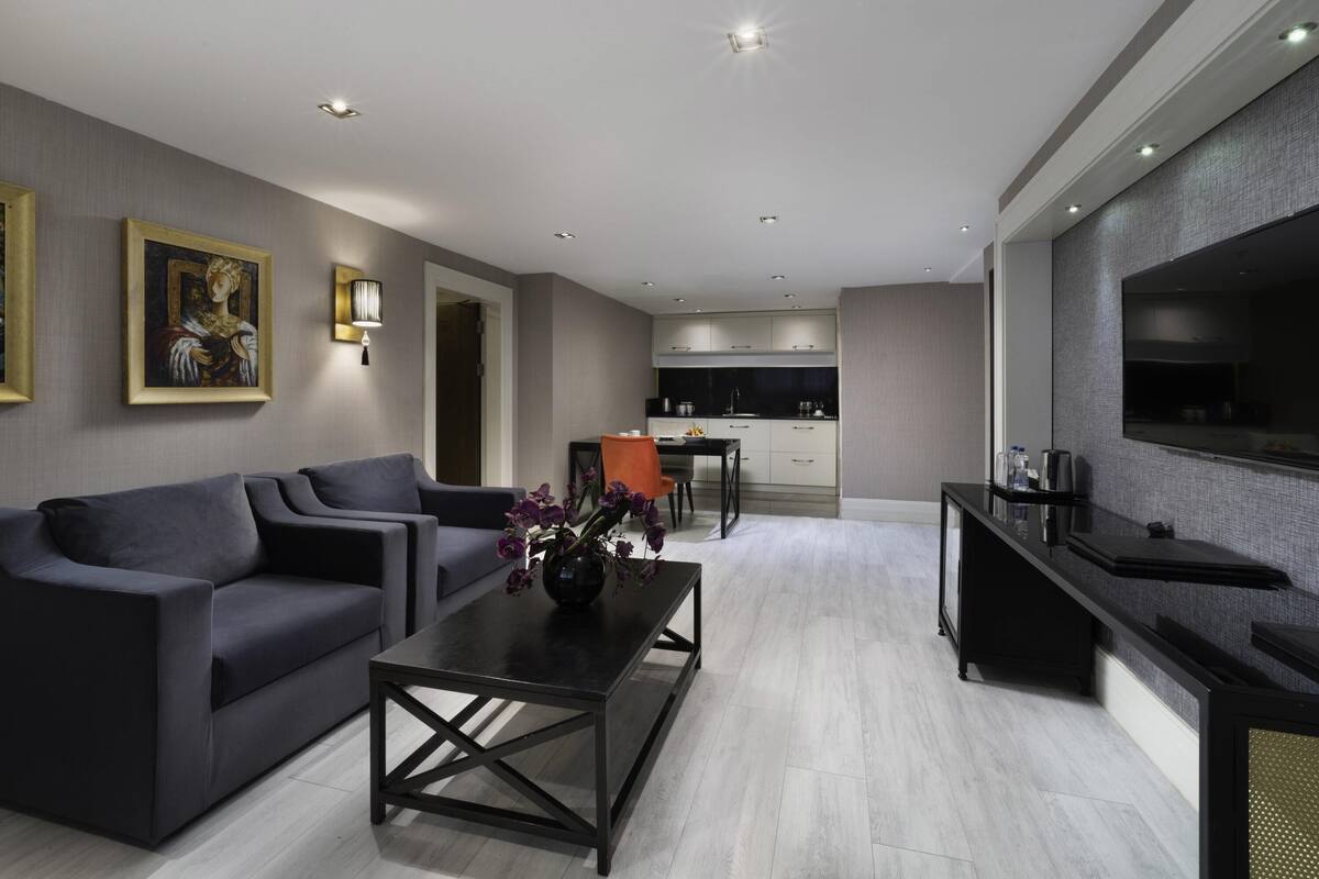 A modern living room with a sofa, coffee table, and a TV.