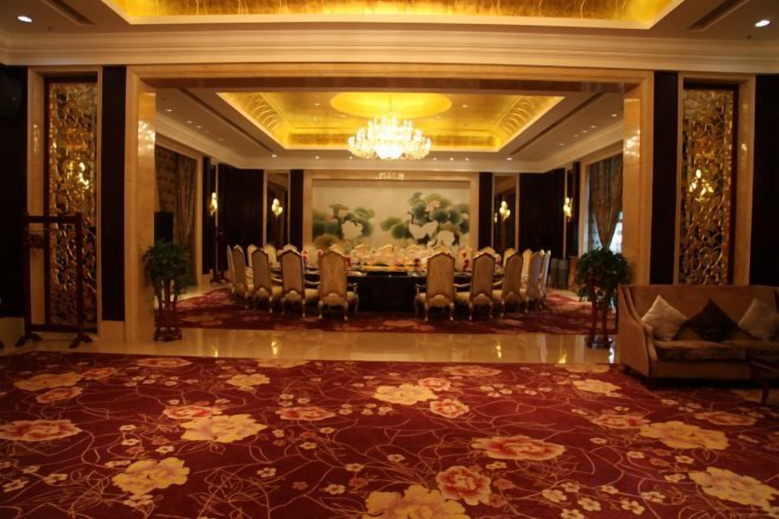 A formal dining room with a long table, chairs, and a chandelier.