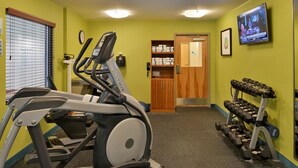 A gym with a treadmill, dumbbells, and a television on the wall. - Holiday Inn Express & Suites West Ocean City by IHG (Ocean City)
